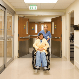a lady on a wheel chair opening a door